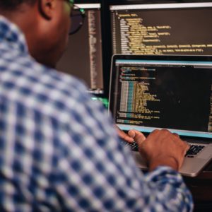 Diversity in tech and stem, African America developer sitting at computers coding
